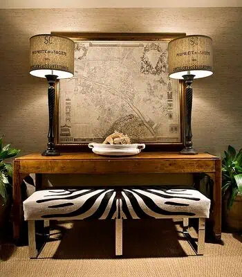 Why Antique Maps Are Trending in Home Decor Right Now 4 Antique map framed on wall with lamps and bench in stylish interior.
